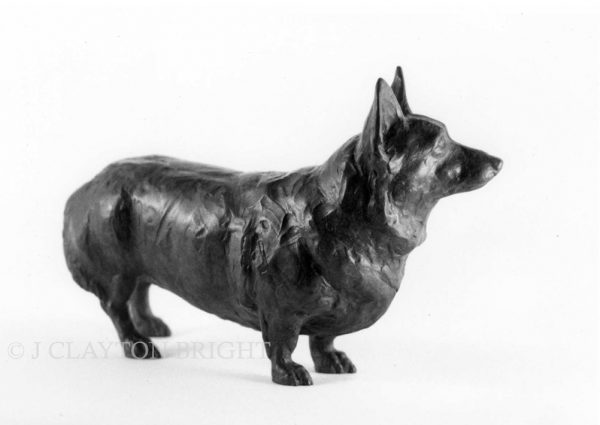 Realistic bronze sculpture of a Corgi dog looking ahead expectantly