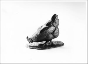 Realistic bronze sculpture table-size of a chicken pecking the ground