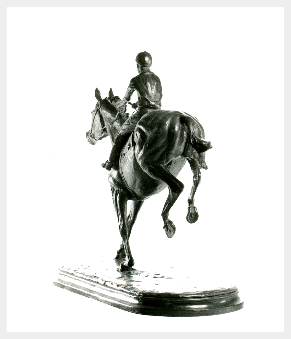 Realistic bronze sculpture of a horse landing on its front legs after jumping hind legs still flexed in the air. Rider leaning back reins loose. Sculpture on a base.