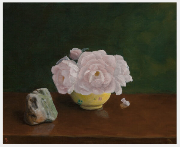 Realistic still life oil painting of pink roses in a yellow bowl next to a small multicolored rock, all on a table.