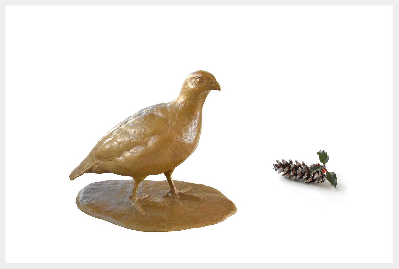 A realistic life-size bronze quail sculpture stepping forward on a base.